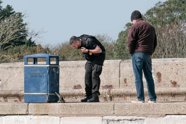 A police officer inspects the device. Picture: Matthew Maber (Instagram @mattmaber)