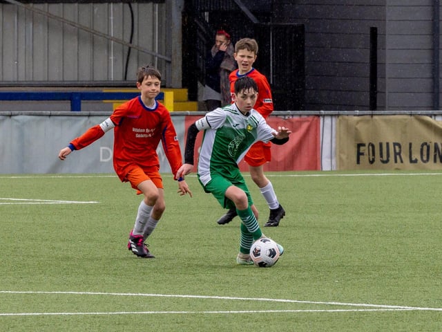 Action from the Under-13 Truman Challenge Cup final between Denmead Youth Lions (orange shirts) and Moneyfields Youth Yellow. Picture: Mike Cooter