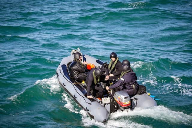 A team of divers and engineers from minehunter HMS Middleton rush to the aid of a stricken fishing boat in the Solent. Photo: Royal Navy