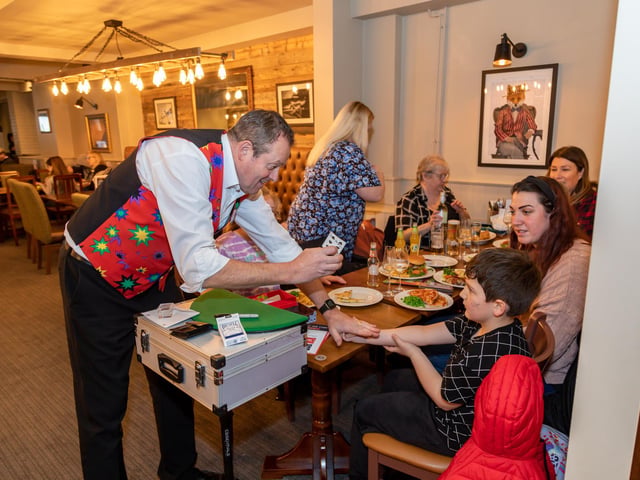 Magician Roy 'Magic Charlie' Charles provides entertainment during the opening of the Brewers Fayre. Picture: Mike Cooter (040323)