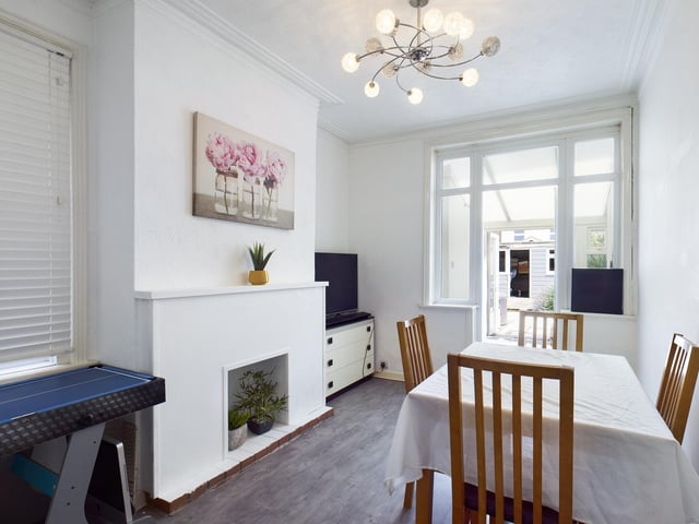 The rear reception space is perfect for a dining room, and also has the original coving