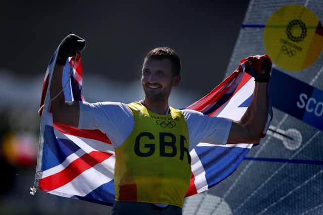 Giles Scott of Team Great Britain celebrates on the podium for the Men's Finn class on day eleven of the Tokyo 2020 Olympic Games. Photo by Clive Mason/Getty Images