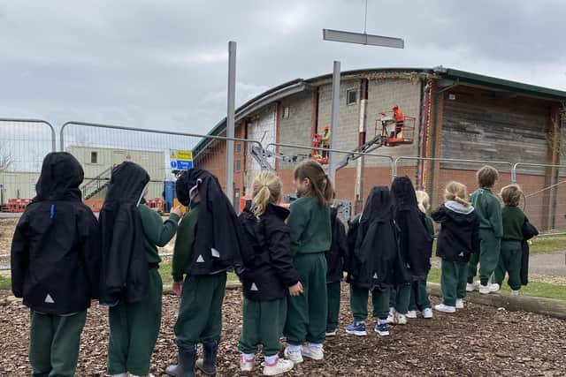 Nursery pupils watch construction work taking place on the new sports facility at Ditcham Park School.