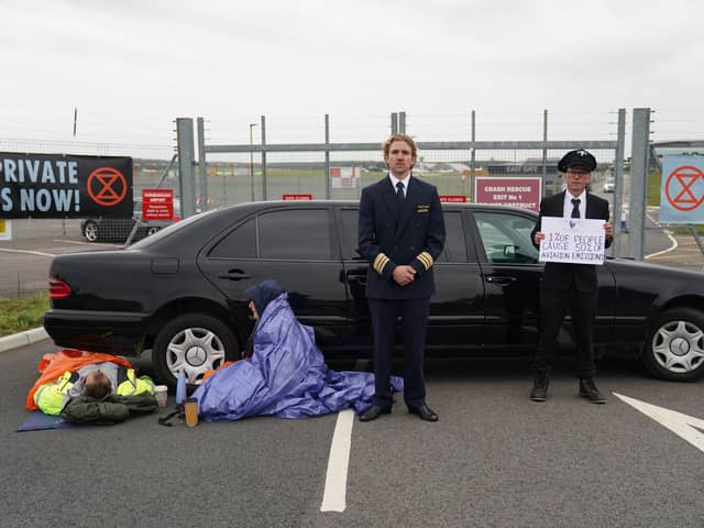 Extinction Rebellion activists protest outside Farnborough Airport in Hampshire in protest against emissions from private jets. Picture date: Saturday October 2, 2021. PA Photo. See PA story ENVIRONMENT Airport. Photo credit should read: Andrew Matthews/PA Wire