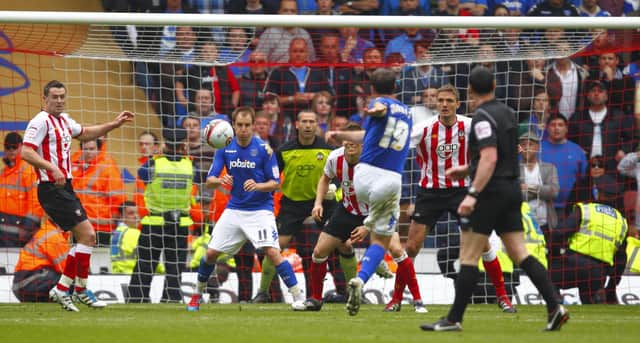 David Norris unleashes a stunning left-foot volley to snatch a point at the death for Pompey against Southampton. Picture: Chris Ison