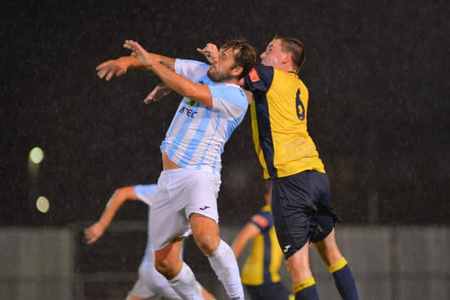 Blu Boam and Tom Cain rise for a header. Picture: Martyn White