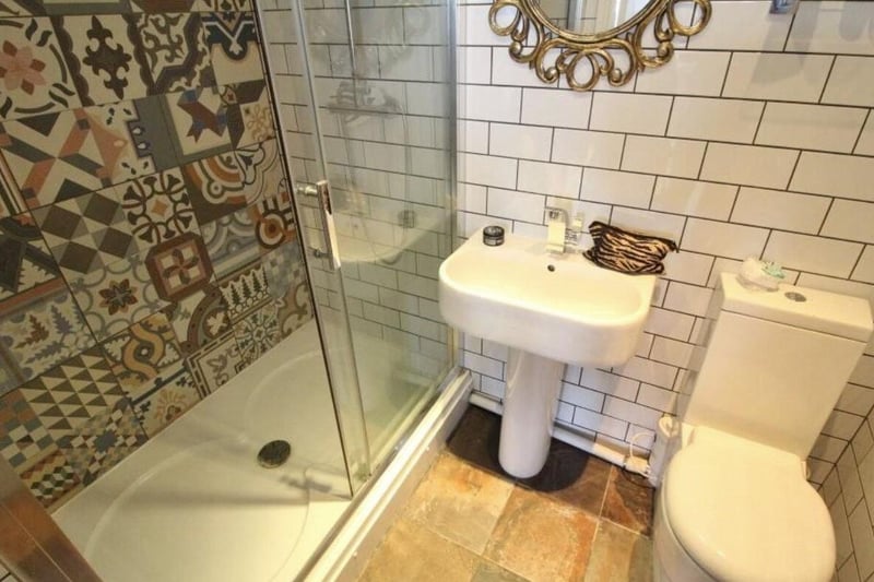 The house has a spacious garden and a driveway.