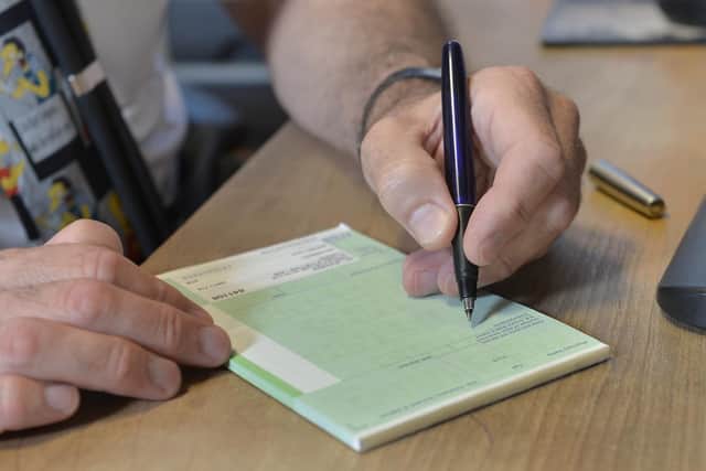 A GP writes out a prescription