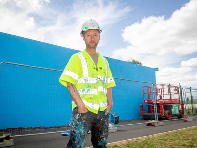 Artist, My Dog Sighs, begins to paint a mural on the building of Hilsea Lido Swimming Pool on 20th July 2020. 

Pictured:  Artist, My Dog Sighs.

Picture: Habibur Rahman