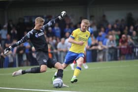 Pompey goalkeeper Alex Bass clears at Hawks. Picture: Kieron Louloudis