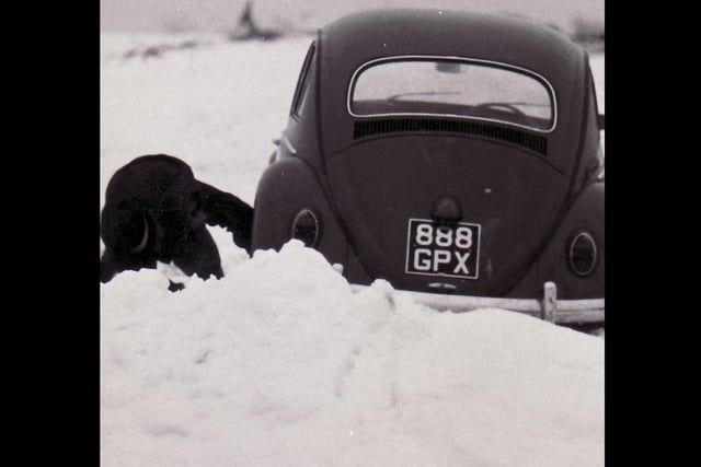 A motorist struggles to clear deep snow away from his car in the Big Freeze of 1963.