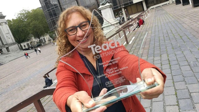 Cllr Suzy Horton holding one of the Teach Portsmouth Awards