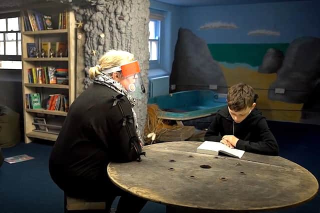 Inside 'The Cave', a volunteer reads with a student from the Pompey Pirates. Picture: Literacy Hubs