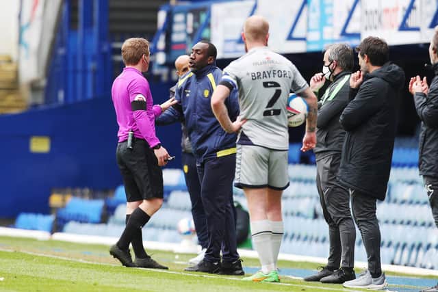Referee John Busby has words with Burton's Jimmy Floyd Hasselbaink