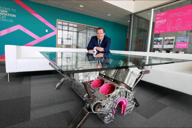 Centre Director Stephen Brownlie is pictured with a glass-top coffee table fashioned from a V-12 engine from a Second World War Supermarine Spitfire.