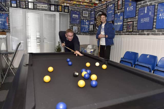 Aaron Haggard plays pool with Alan Knight in his games room. Picture: Sarah Standing (111223-3261)