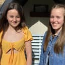 Singers Darcey Jeune (left) and Heidi Bucher have raised £1,450 for the Rowans Hospice.