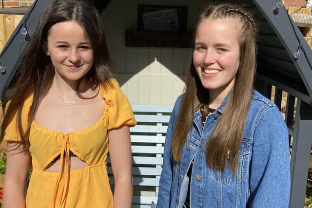 Singers Darcey Jeune (left) and Heidi Bucher have raised £1,450 for the Rowans Hospice.