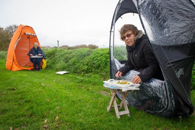 Angela Barnes and her friend Janice Burkinshaw are both widows who have supported each other through the Covid restrictions. As they can no longer enjoy Sunday dinner in Janice's garden they bought pop-up pods which they put up on Milton Common to enjoy a 2-course dinner

Pictured: Angela Barnes and her friend Janice Burkinshaw having their lunch on Milton Common,  Portsmouth on 11 November 2020.

Picture: Habibur Rahman