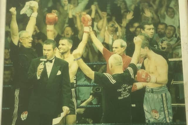 Frank Hopkins, far left, with his arms aloft after nephew Tony Oakey had just been crowned WBU world light heavyweight champion.