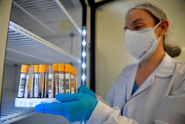 A health worker places tubes in a fridge at the new COVID-19 test centre. Picture: RAUL ARBOLEDA/AFP via Getty Images