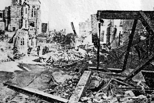 The remains of Knight and Lee’s store after the night of January 10, 1941. The spire of St Jude’s Church on the left.