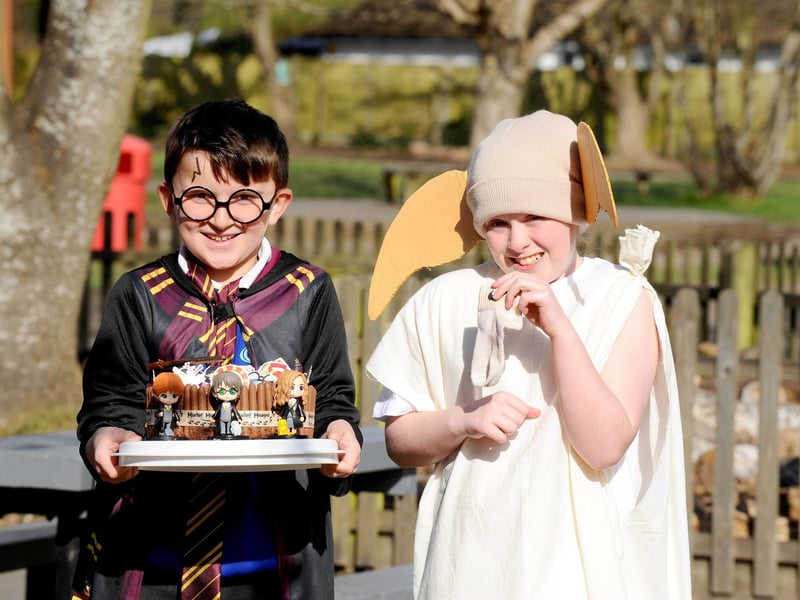 Gomer Junior School in Gosport, dressed as their favourite book characters, baked caked and took part in online quizzes to mark World Book Day.Pictured is: Charlie Brown (7) as Harry Potter and Bonnie Scott (9) as Dobby.Picture: Sarah Standing (070324-6448)