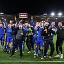 The Grimsby players and staff celebrate their FA Cup fifth round win against Southampton at St Mary's   Picture: ADRIAN DENNIS/AFP via Getty Images