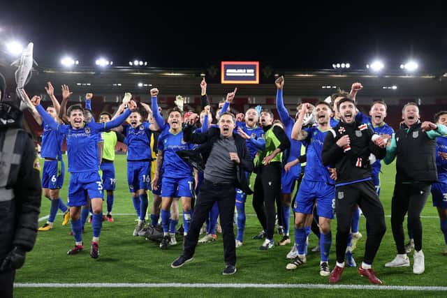 The Grimsby players and staff celebrate their FA Cup fifth round win against Southampton at St Mary's   Picture: ADRIAN DENNIS/AFP via Getty Images