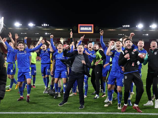 The Grimsby players and staff celebrate their FA Cup fifth round win against Southampton at St Mary's   Picture: ADRIAN DENNIS/AFP via Getty Images