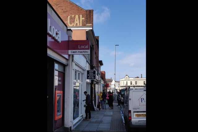 This sign in Albert Road, above The French, reads 'Cafe' - with contemporary street art below.