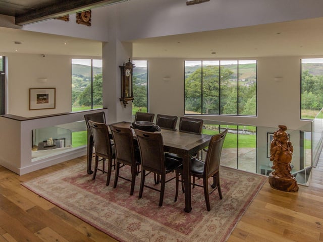 The dining space is light and airy, and offers plenty of room for family meals and entertaining guests, with views overlooking the gardens.
