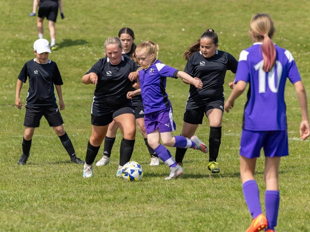 Stoneham Lionesses (purple kit) take on Bedhampton Hawks (black kit) in the Clanfield youth football tournament at Horndean Technology College. Picture: Mike Cooter