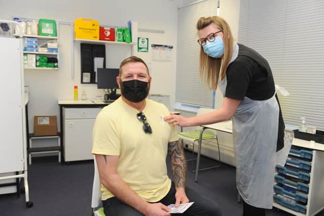 More than 100,000 people in Portsmouth have now had at least one Covid vaccination, and 360,000 across Portsmouth, Fareham, Gosport, Havant and East Hampshire have had theirs. The News, Portsmouth, visited Lalys Pharmacy in Guildhall Walk, Portsmouth on April 22.

Pictured is: Dean Fitzgerald (47) from Hilsea, with vaccinator Sophie Furmedge.

Picture: Sarah Standing (220421-7042)