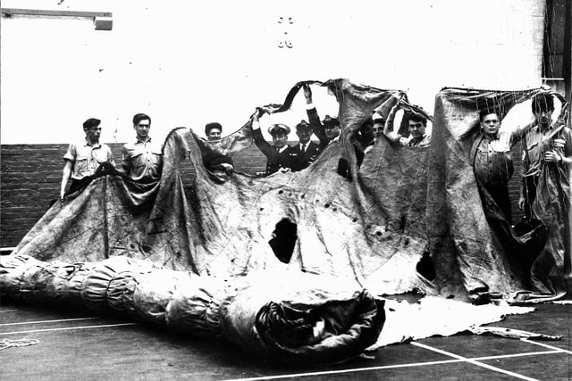 Sailors in the gym of HMS Nelson, c.1967, stretching out the fore topsail from HMS Victory, the sole surviving sail from the Battle of Trafalgar. The sail disappeared for a century before it was found again.