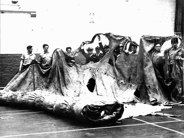 Sailors in the gym of HMS Nelson, c.1967, stretching out the fore topsail from HMS Victory, the sole surviving sail from the Battle of Trafalgar. The sail disappeared for a century before it was found again.