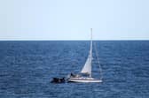 HMS Dragon comes to rescue of stricken yacht off a Dorset beauty spot.