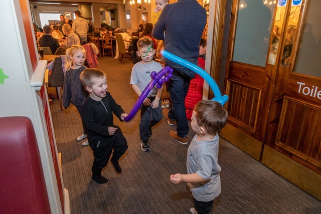 Theodore Legg (1) and Elijah Worrell (3) test out their balloon swords in battle. Picture: Mike Cooter (040323)
