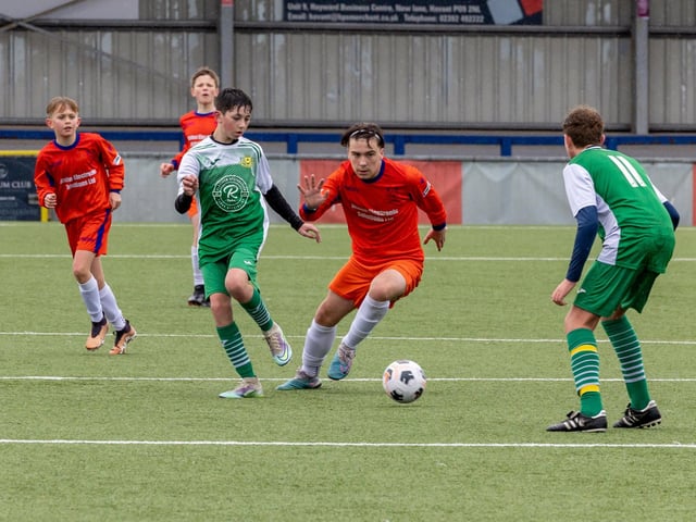 Action from the Under-13 Truman Challenge Cup final between Denmead Youth Lions (orange shirts) and Moneyfields Youth Yellow. Picture: Mike Cooter
