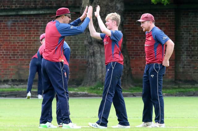 Matty Hayward, centre, 15, is congratulated after taking a wicket in Havant's victory over Bashley. Picture: Chris Moorhouse