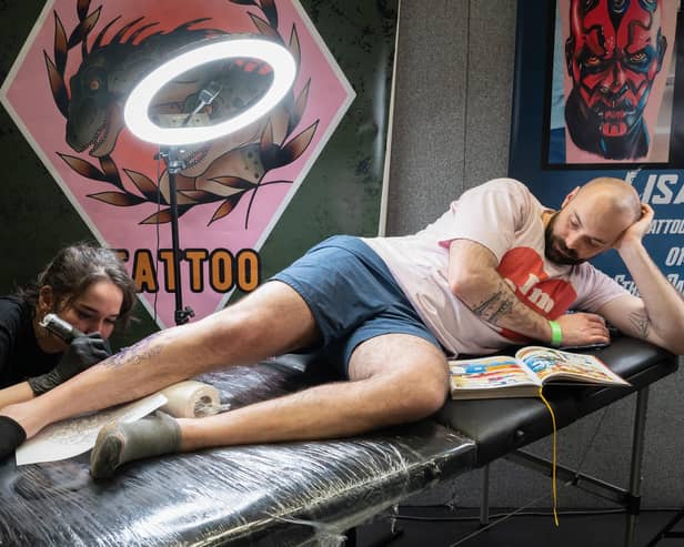 The Mountbatten Centre held the two day event which gathered together more than one hundred world-class tattoo artists. In this picture Kit Wagstaff works on the leg of Yohan.
Picture from last year. 
Picture: Keith Woodland