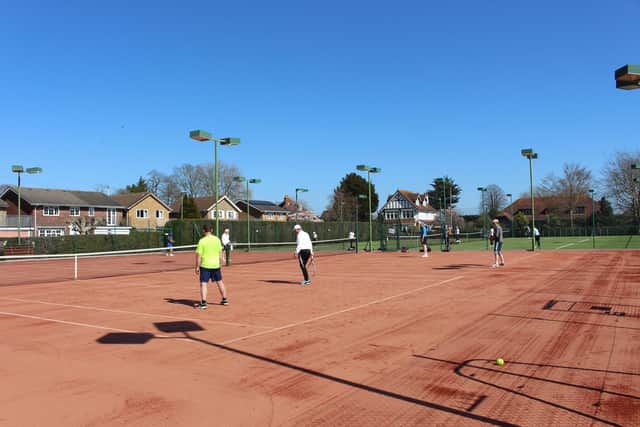Tennis players enjoy the sunshine while on the court. Picture: Emily Turner