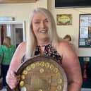 Landlady Deana Geary holding the CAMRA trophy.