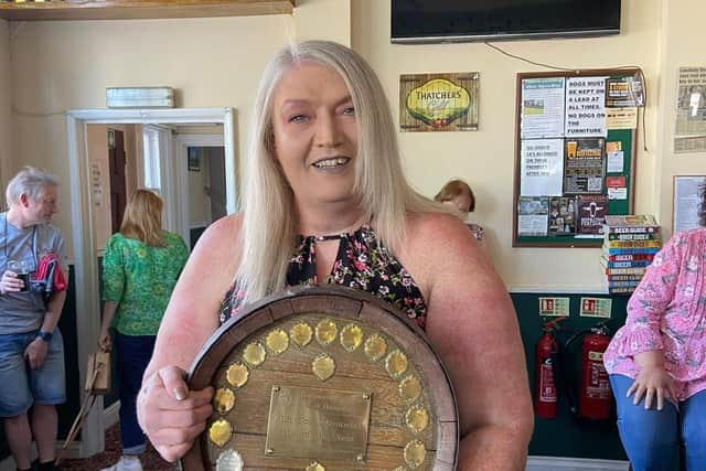 Landlady Deana Geary holding the CAMRA trophy.