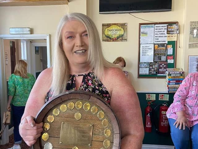 Landlady Deana Geary holding the CAMRA trophy.