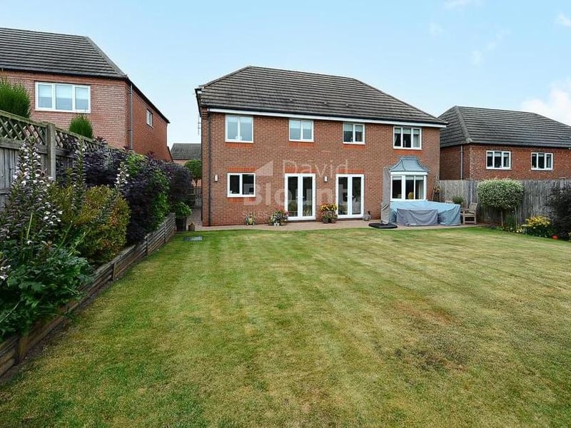 This picture gives a good idea of how the Mayflower Court property looks from the back. A lawn for playing games or relaxing in the sun.