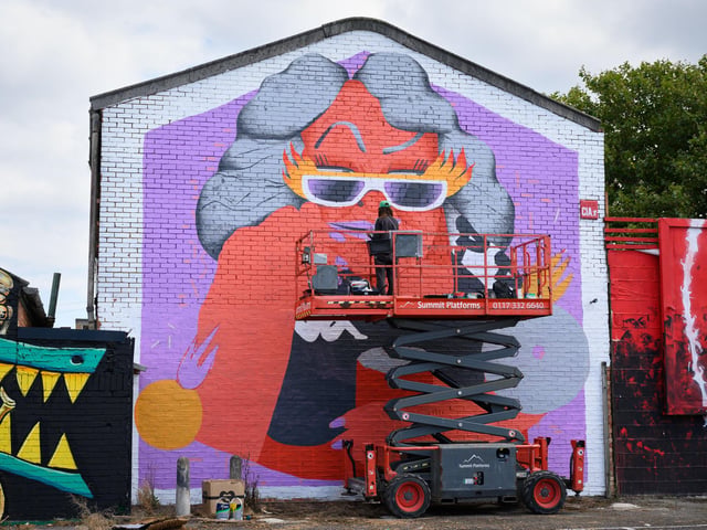 Pictured is: Marina Cadevila at work on her artwork in Clarence Street Carpark
Picture: Keith Woodland (140921-6)