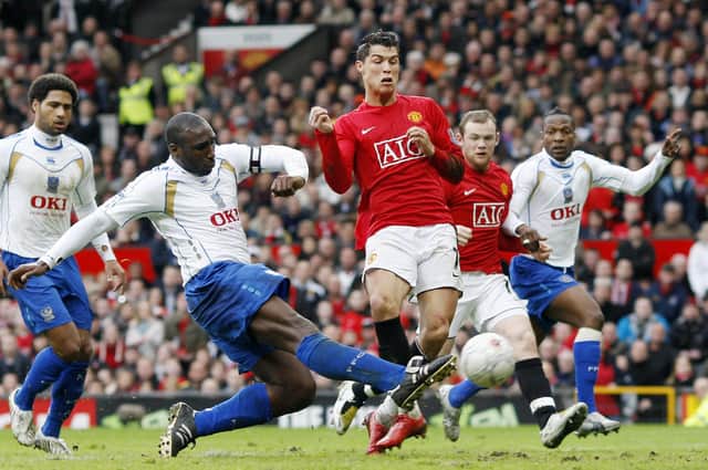 Sol Campbell clears from Ronaldo at Old Trafford in the FA Cup quarter-finals in March 2008. Picture: ADRIAN DENNIS/AFP via Getty Images
