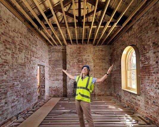 The former police barracks in Haslar Gunboat Yard in Gosport was restored after it was placed on the Historic England at risk register. Pictured: Louisa Fifield from Hornet Services Sailing Club shows the repairs to the Former Police Barracks.