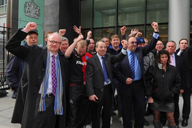 Pompey fans celebrate saving their club from liquidation outside the Rolls Building at the High Court in April 2013 - with Micah Hall in the centre. Picture: Sarah Standing